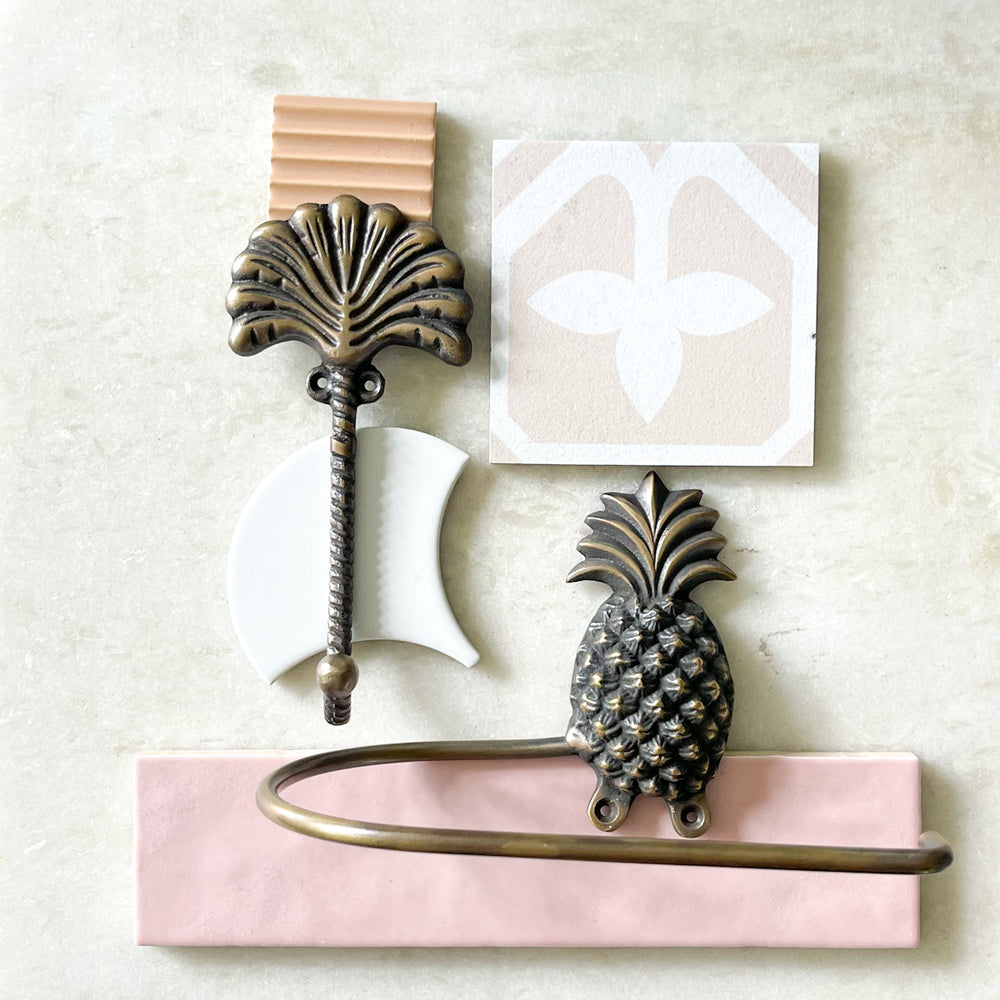 Pineapple toilet roll holder and fan palm mood board on tiles by Ocean Luxe